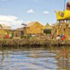 people near brown thatched houses across river